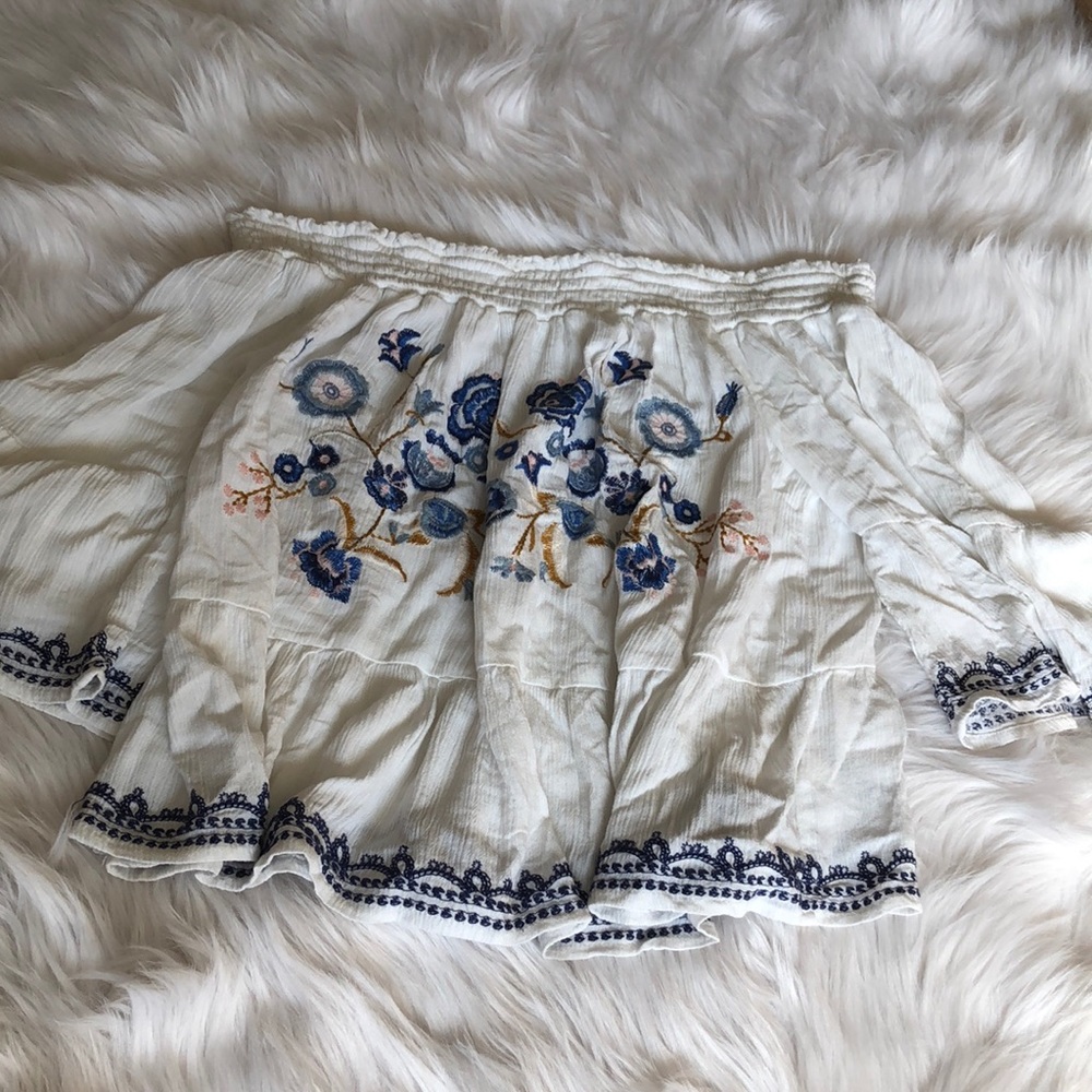 target white embroidered bell sleeved top.